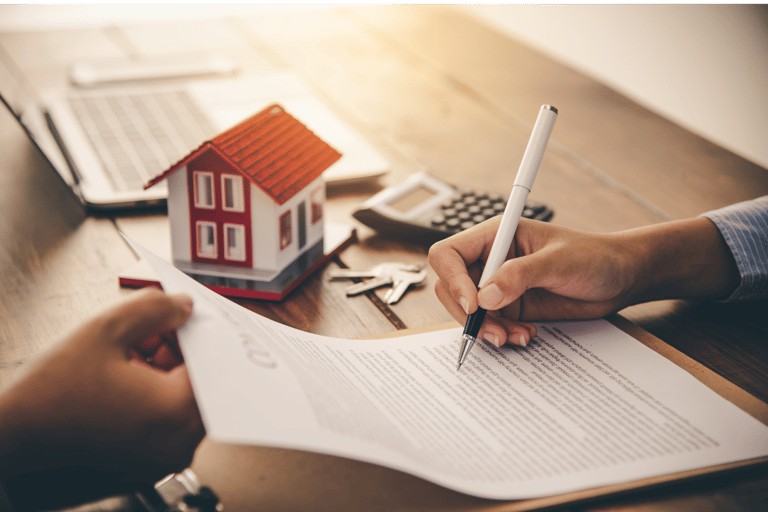 a person holding a pen and writing on a paper