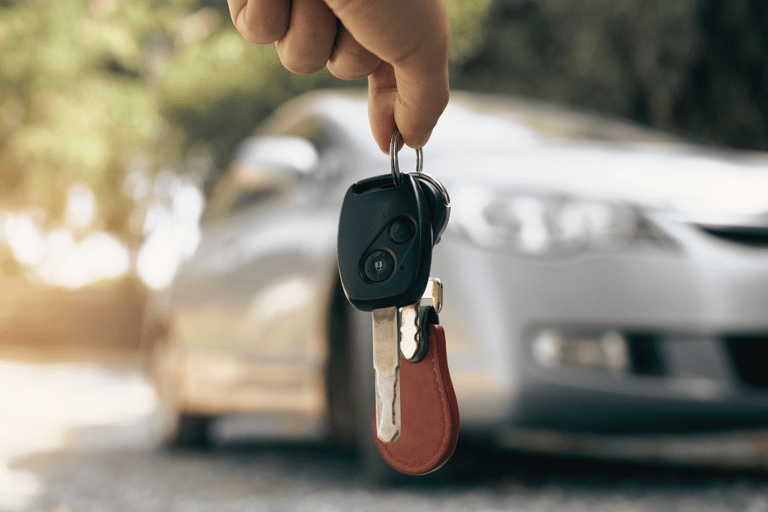a person holding a keychaik in their hand