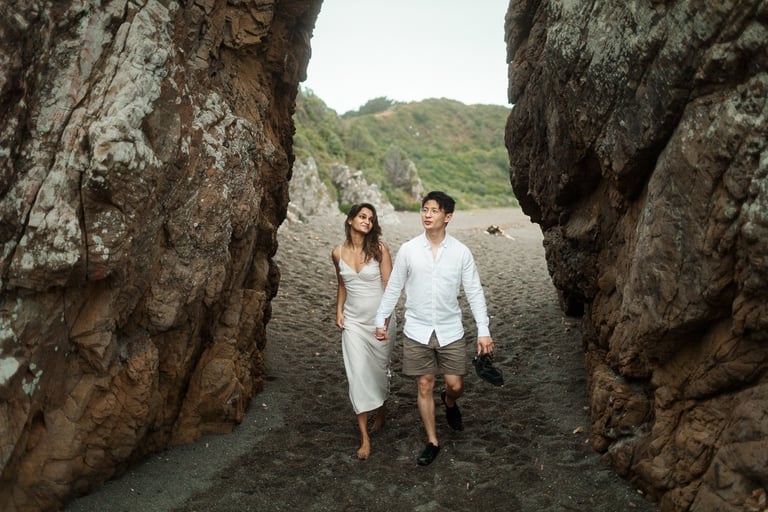 a couple walking through a cave in a cave