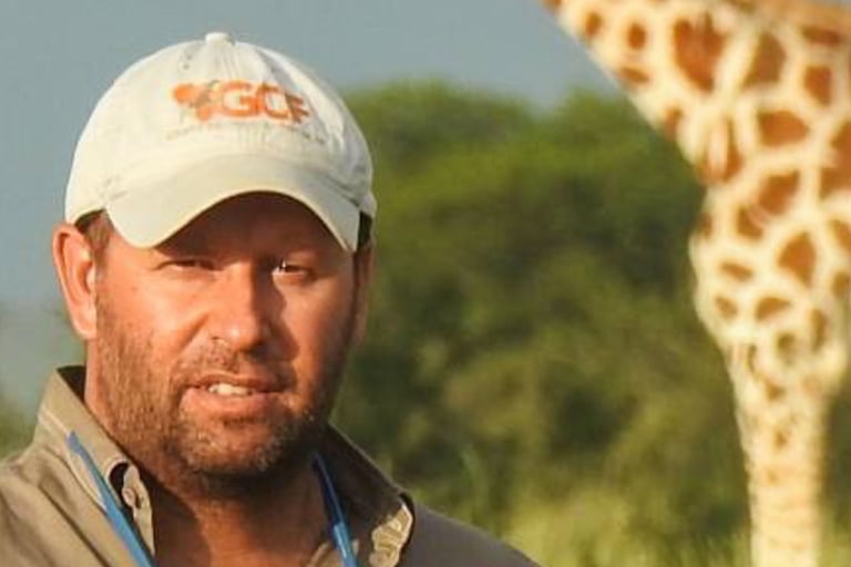 Dr Fennessy portrait with giraffe in background