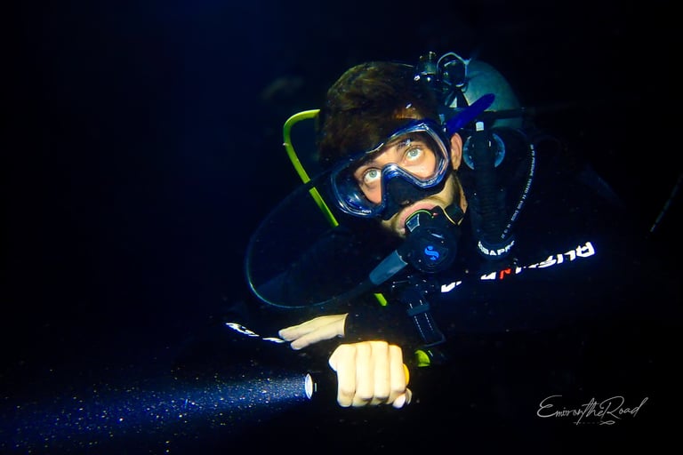 Experienced night diver exploring the vibrant marine life of Gili Trawangan after sunset with Gili Scuba Diving.