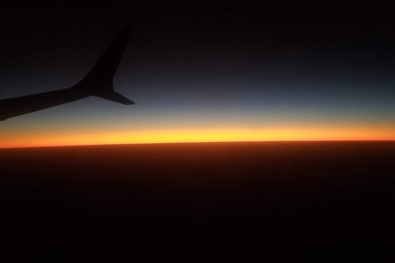 unique view you can only get when flying. Beautiful Sunset from Airplane.