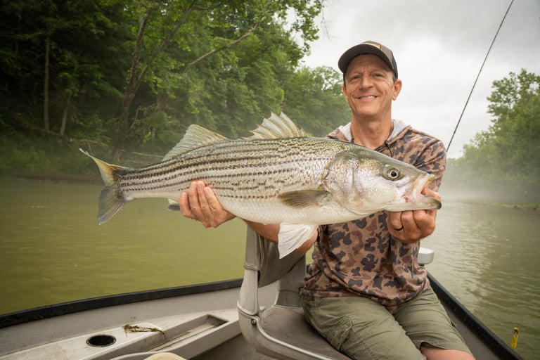 Eric with 1 of 3 striped bass caught on the fly rod