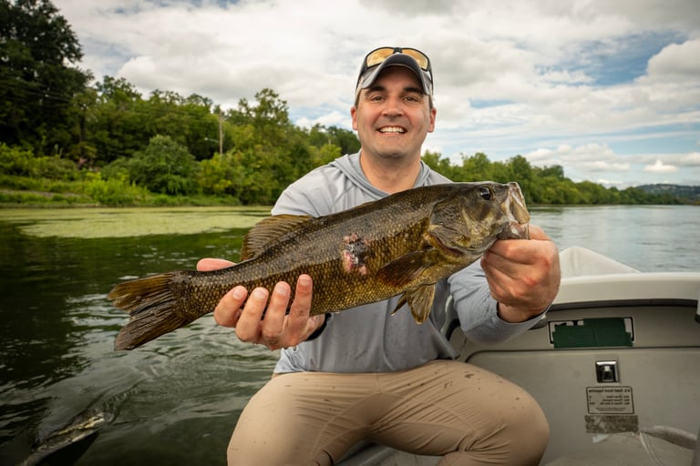 John with a streamer eating smallmouth