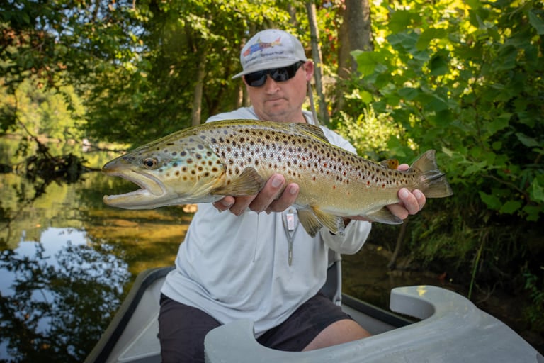 Guide Joe Kostura with an August brown trout