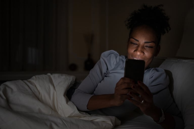 Woman privately messaging on her phone at night representing confidential WhatsApp support