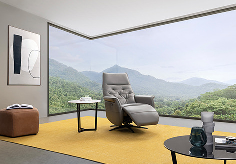 a living room with a large window and a view of the mountains