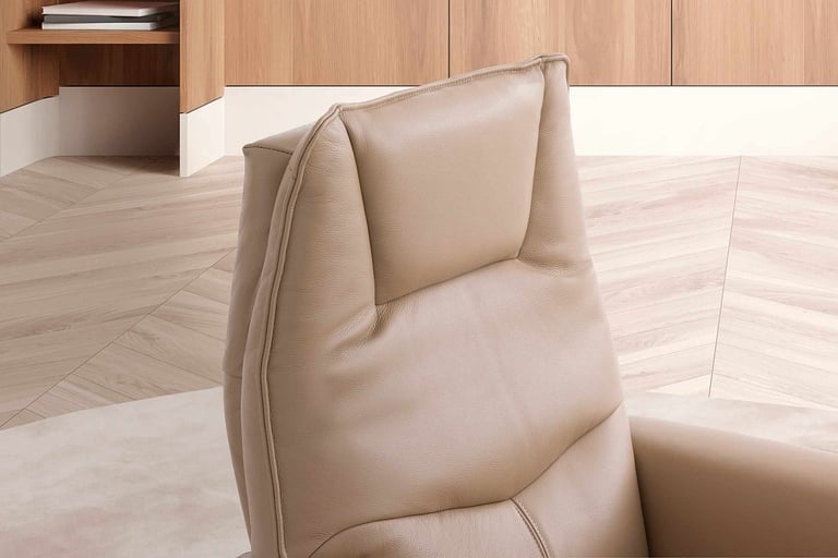 a chair with a bookcase and a book shelf