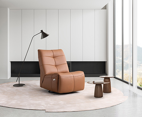 a living room with a chair and a lamp