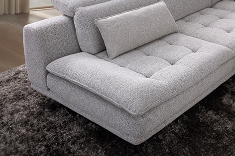 a couch with pillows and pillows on a rug