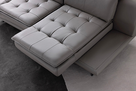 a couch with a large ottoman and a chair