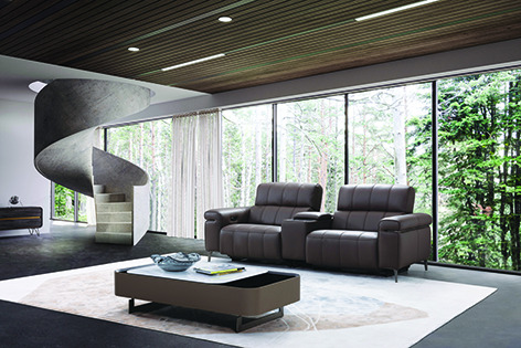 a living room with a spiral staircase going up to the top floor