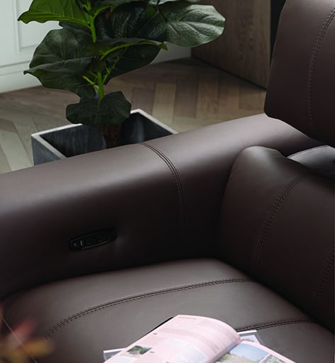 a book is sitting on a couch with a magazine