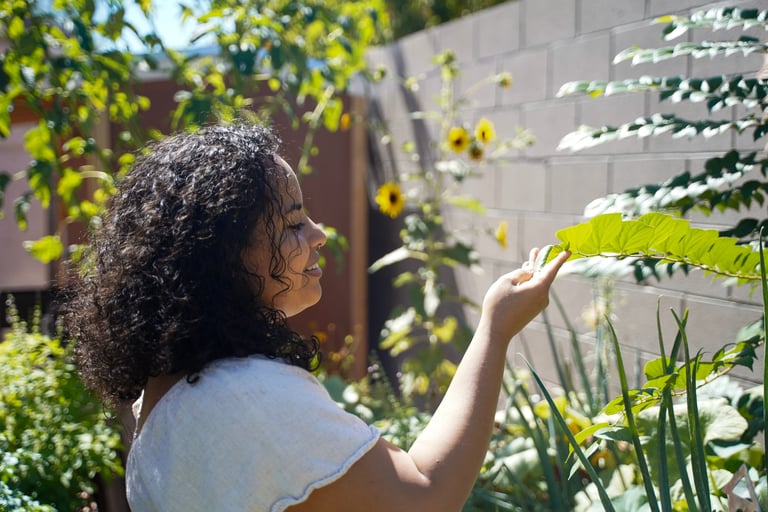 Iveth Balanta holding a leafy plant in her hand