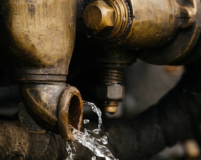 Water flowing out of a brass well fitting