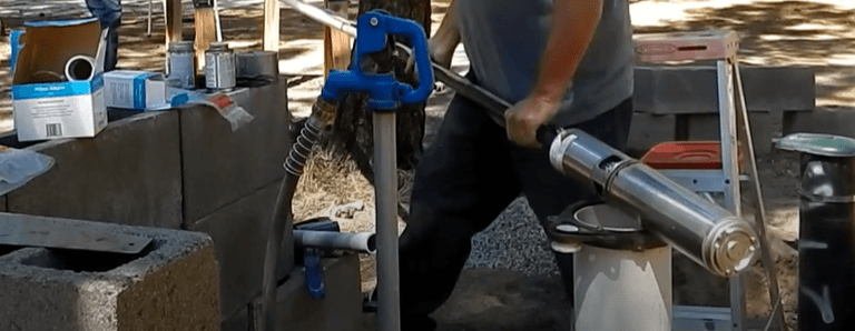 Technician about to snake the well pump into the well