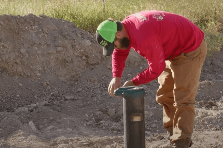 man working on well pump cover