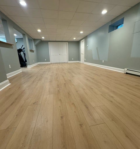 basement remodeling project with new flooring and drop ceiling Hanover MA