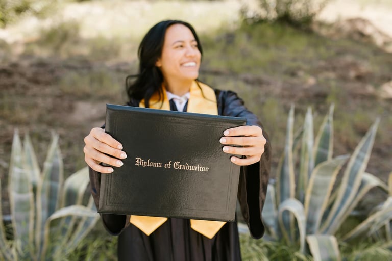 a woman in a graduation gown holding a diploma certificate