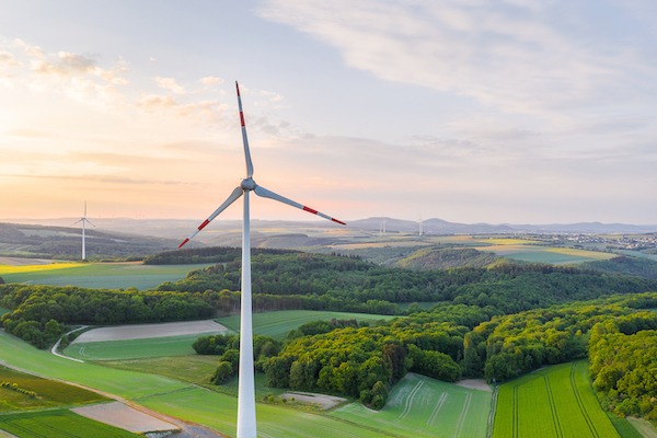Windrad in grüner Landschaft
