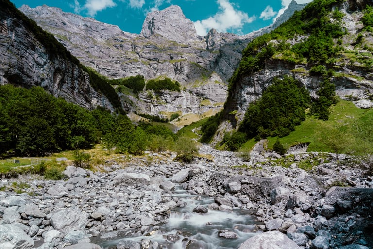 a mountain stream running through a rocky mountain