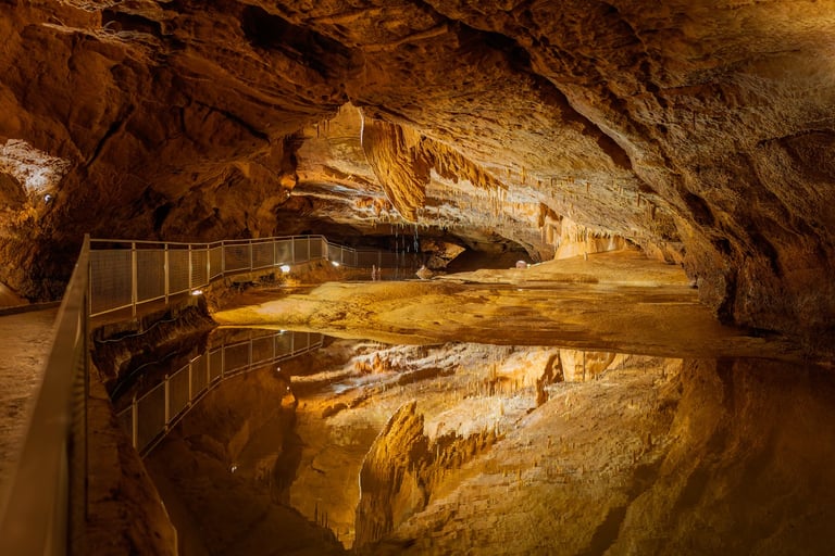 a cave like structure with a pool and a waterfall