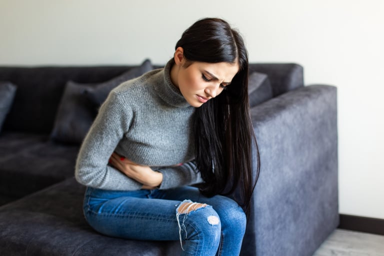A woman having stomach ache after fibermaxxing