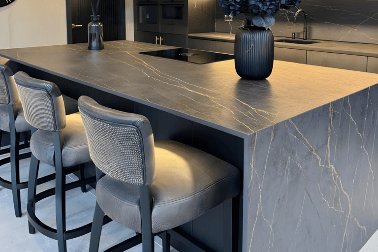 Dark marble-effect porcelain kitchen island with waterfall edges installed by RH Stone Surfaces in t