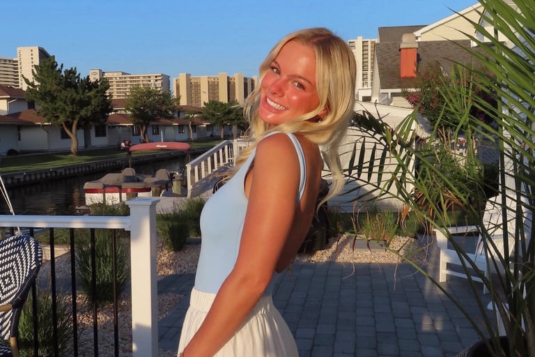 Portrait of Whitney smiling outdoors, representing her professional and creative personality.