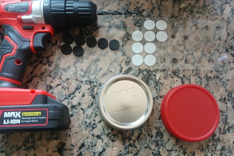 Mycology lid supplies set out on a table: blank jar lids, drill, self-healing injection ports, and f