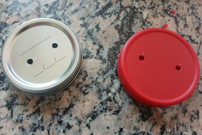 Jar lids with holes drilled, ready for adding filter patches and injection ports.