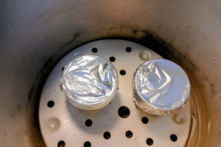 two jars sitting in a pressure cooker for mycology