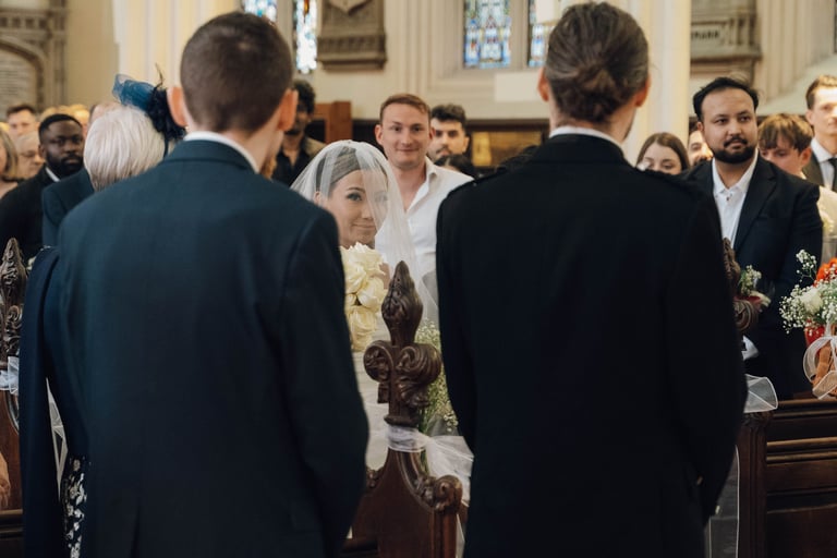 a bride and groom walking down the aisle of a church
