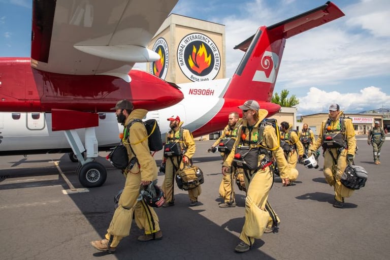 NIFC Smokejumpers in full gear by airplane Photo by Neal Herbert