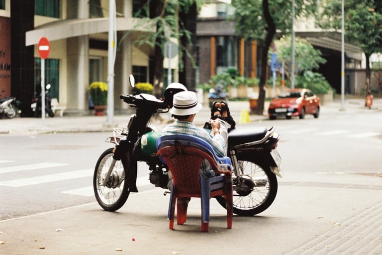 Motorbike driver resting on the street in Saigon