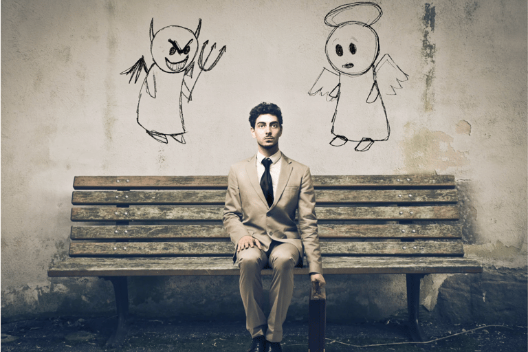 a man in a suit and tie is sitting on a bench