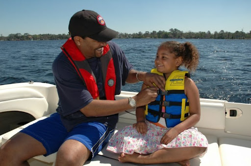 a man and a little girl in life jackets