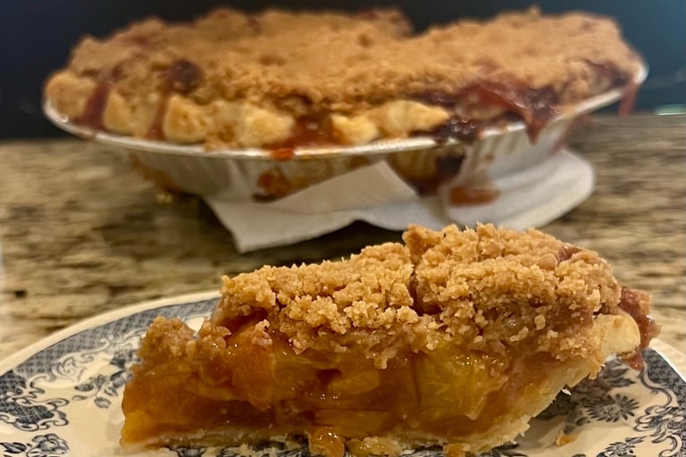 slice of peach pie with crumb top