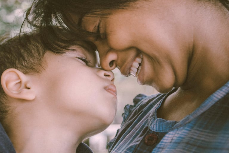 mother and young son touch noses affectionately