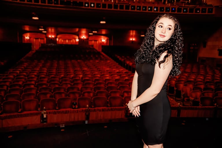 Picture of a high school senior in a Theater for her senior pictures in Hershey PA