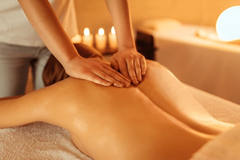 Therapist performing unisex body massage at spa