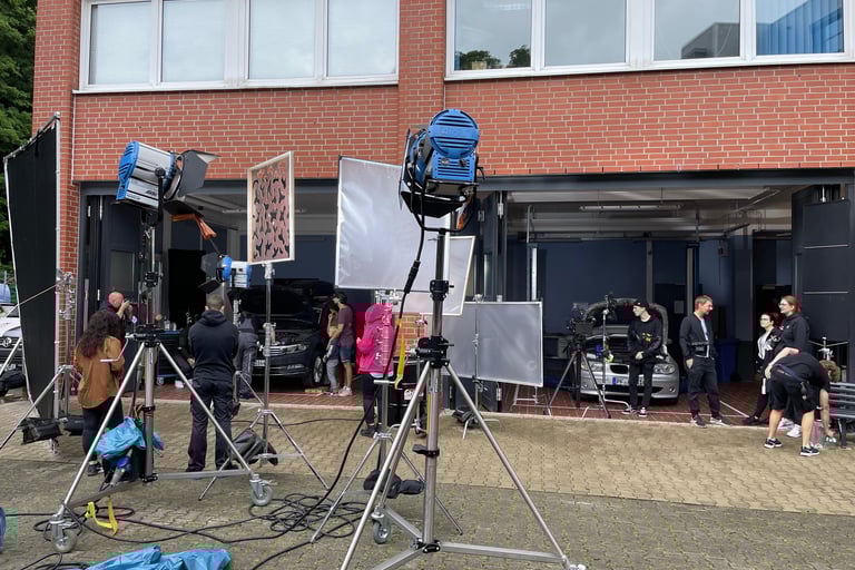 a group of people standing around a camera