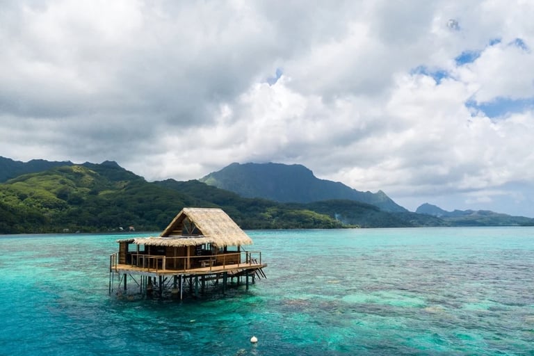 tahitian landscape with house on stilts over turquoise water