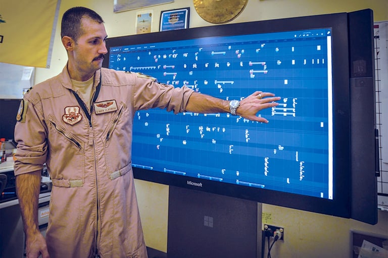 Captain (now Lt Col) Gary Olkowski showing how the Jigsaw application works on a large touch monitor