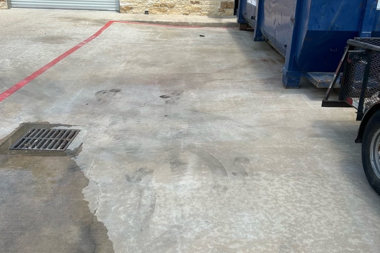 Parking lot after dirt and rust stains from dumpster have been removed