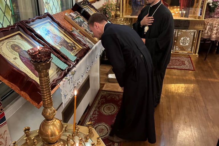 a priest is kneeling down to a priest