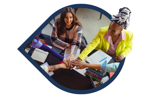 a group of people holding hands together in a circle