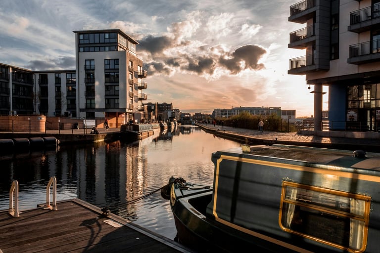 a boat on a river with buildings in the background