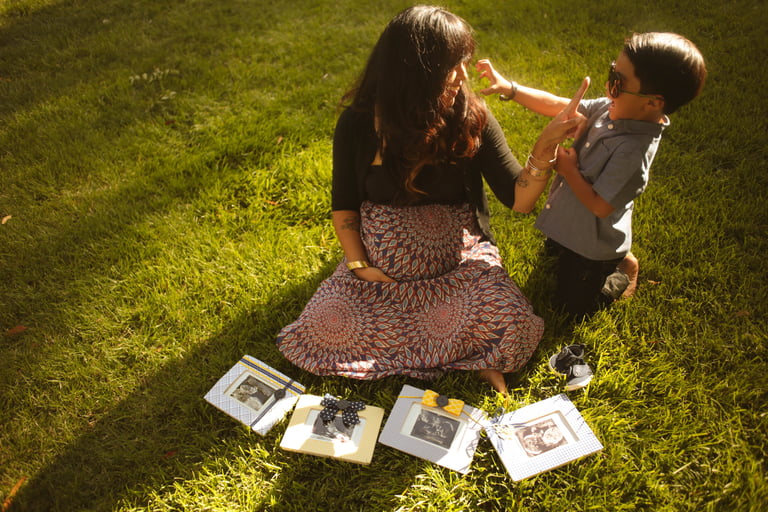 a woman mom and a boy sitting on the grass family photography san diego california