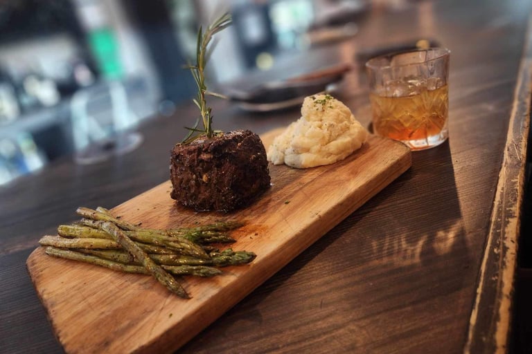 a steak filet dinner asparagus, mashed potato, smoked old fashion